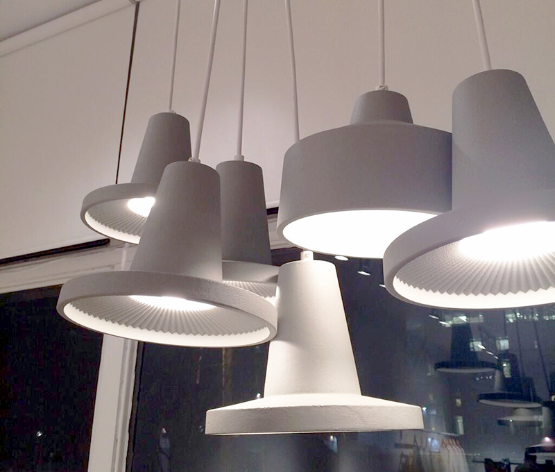 Jonathan Sabine’s cluster of seven pendants are handmade from sand cast aluminum and moulded using 3-D printed nylon. Though the lights themselves are beautiful, it is the moulds — displayed nearby — that impress the most. The pendants are created by pouring molten metal into different impressions in sand with the same computer-generated pattern. Sabine computer-generated new forms and interior patterns and a 3D printer brought these to life in laser-sintered nylon.