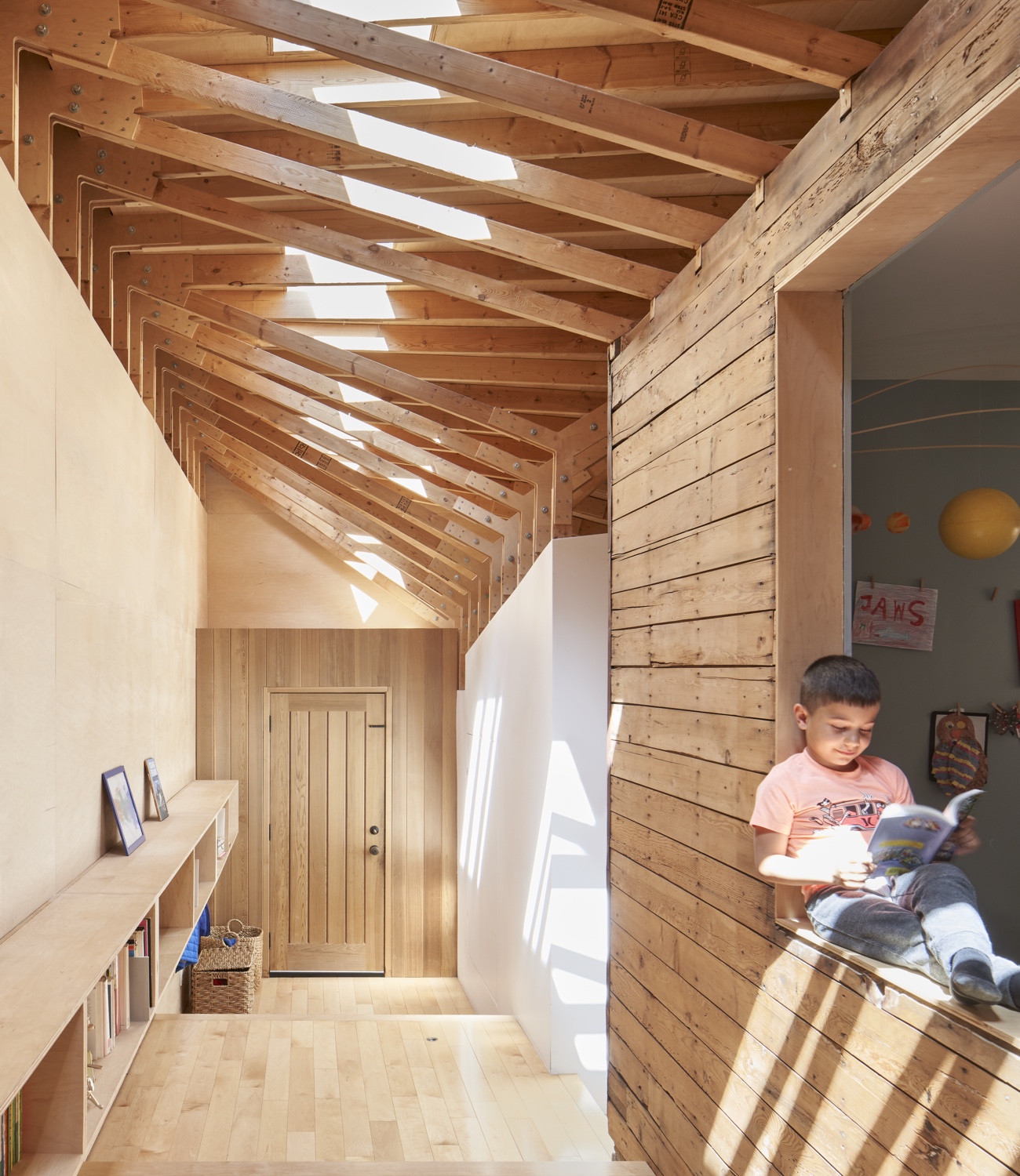 North-facing windows open into a bright, skylit play area in Joey Giaimo’s bungalow addition